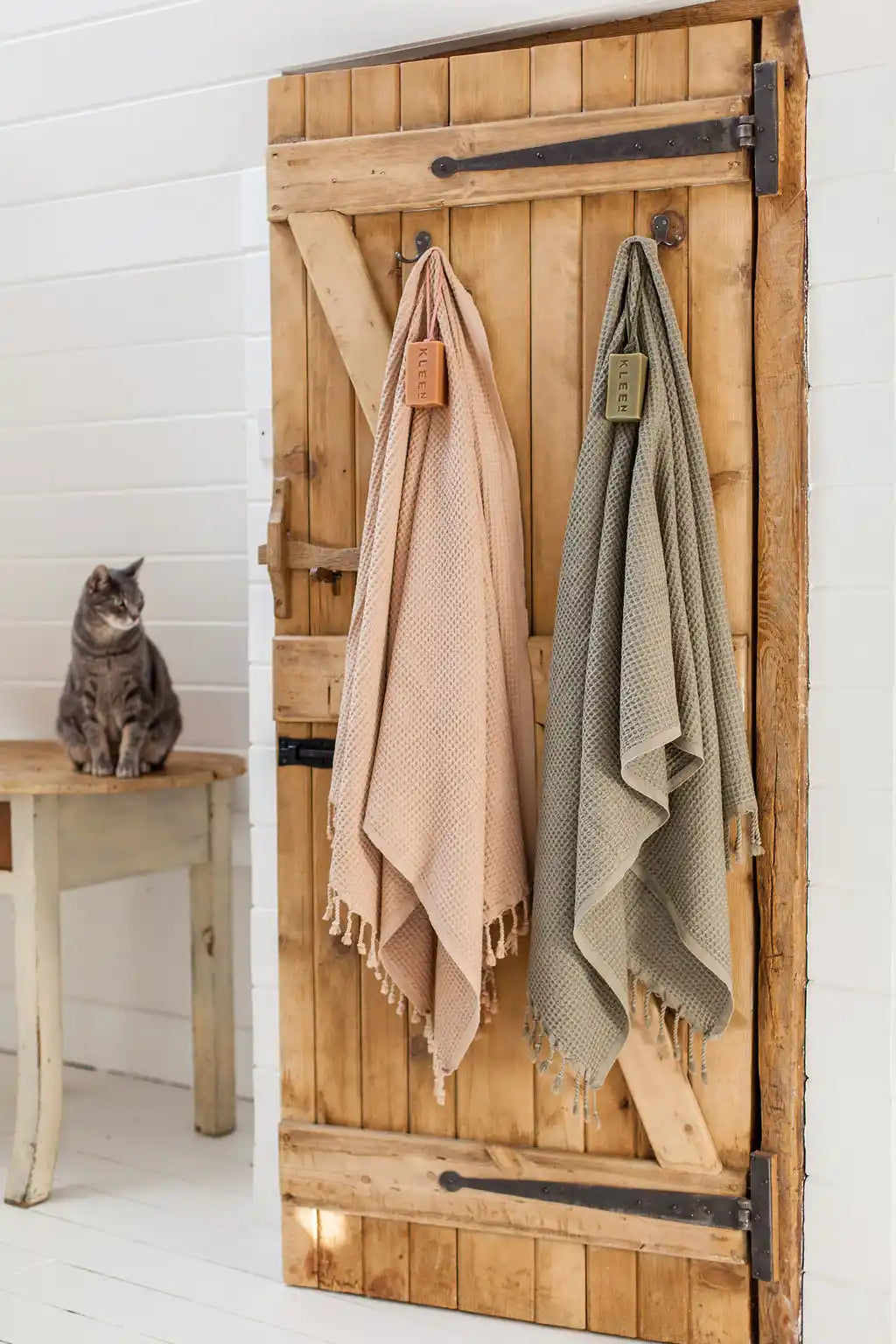 Rustic wooden door with hanging towels.